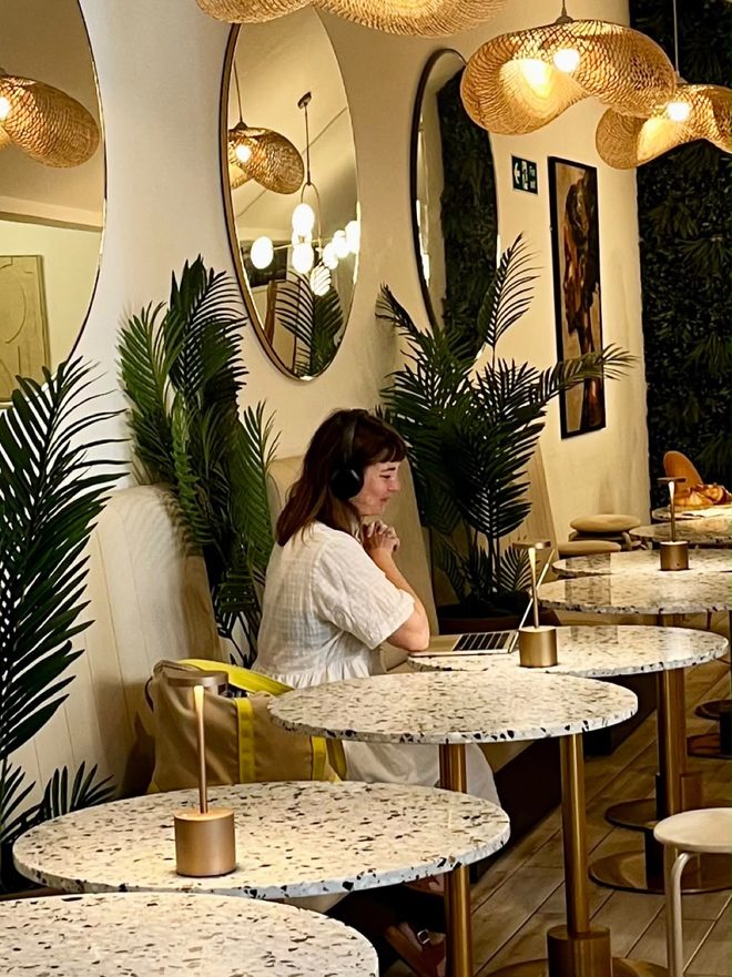 Seating corner with arched mirrors and a foliage wall